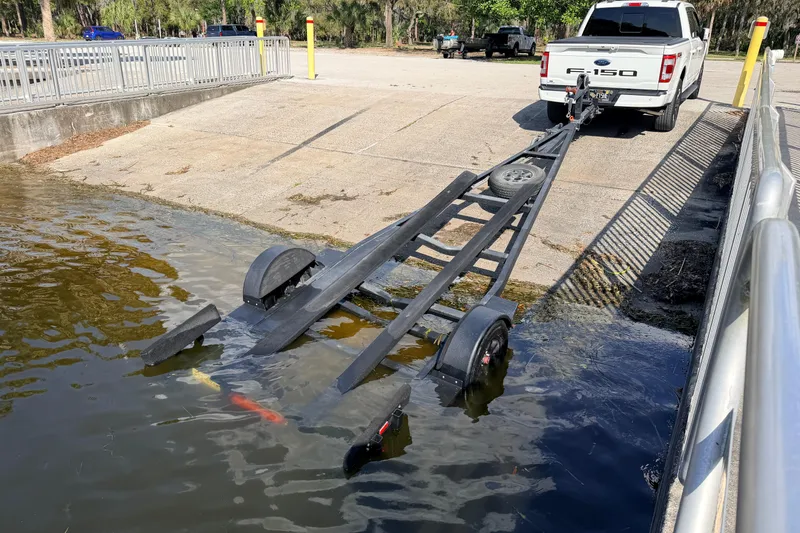 Slide: The Image of Boat trailer submerged at ramp, Chittum Skiffs Islamorada 21, 2022 model. - 79