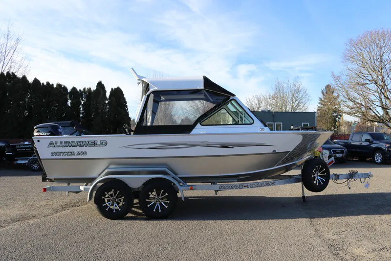 The Image of 2026 Alumaweld Stryker 202 boat on trailer, parked outdoors under clear sky. - 0