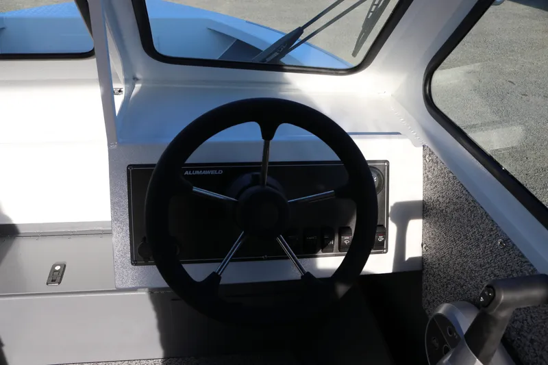 Slide: The Image of 2026 Alumaweld Stryker 202 boat steering wheel and dashboard interior. - 10
