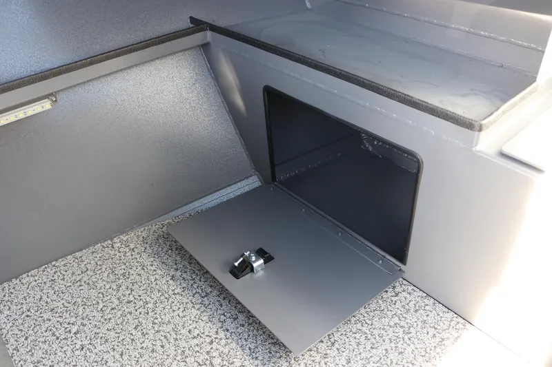Slide: The Image of 2026 Alumaweld Stryker 202 boat storage compartment with open hatch and textured flooring. - 15