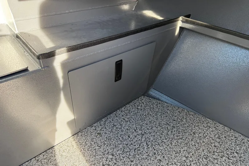 Slide: The Image of Interior of 2026 Alumaweld Stryker 202 boat, featuring storage compartment and textured flooring. - 18