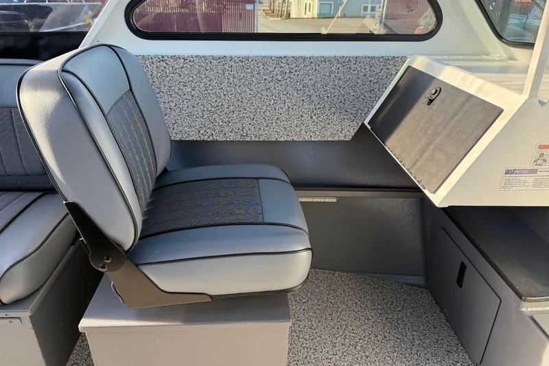 Slide: The Image of 2026 Alumaweld Stryker 202 interior with gray seating and storage compartment. - 19