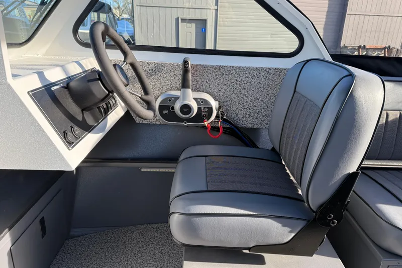 Slide: The Image of 2026 Alumaweld Stryker 202 boat interior with steering wheel and seating. - 20