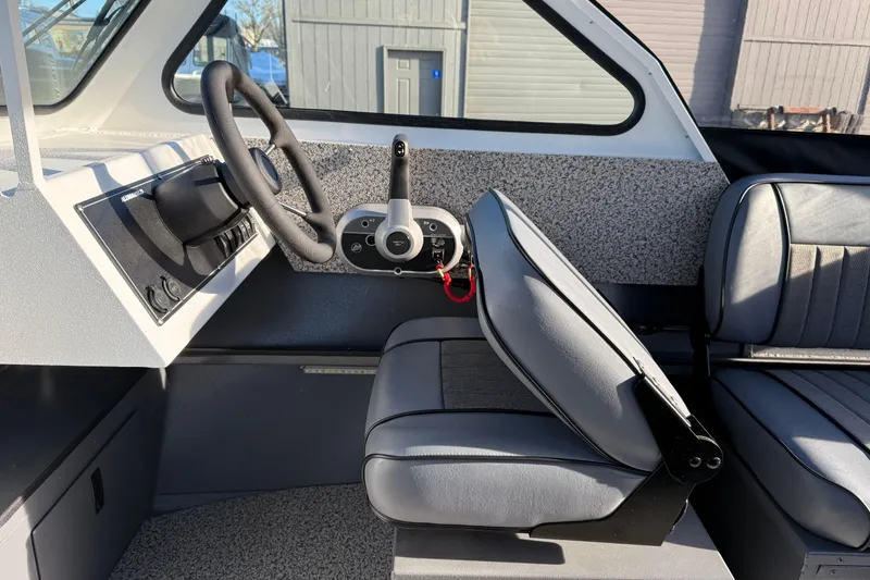 Slide: The Image of Interior of 2026 Alumaweld Stryker 202 boat, featuring steering wheel and seating. - 25