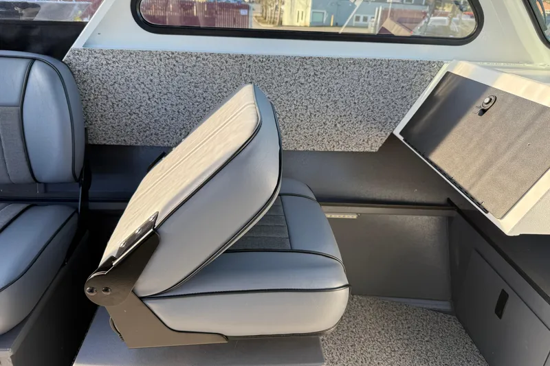 Slide: The Image of Interior of 2026 Alumaweld Stryker 202 boat with gray seating and storage compartment. - 26