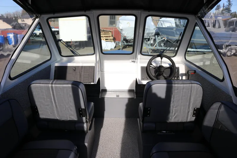 Slide: The Image of Interior view of 2026 Alumaweld Stryker 202 boat, featuring steering wheel and seating. - 7