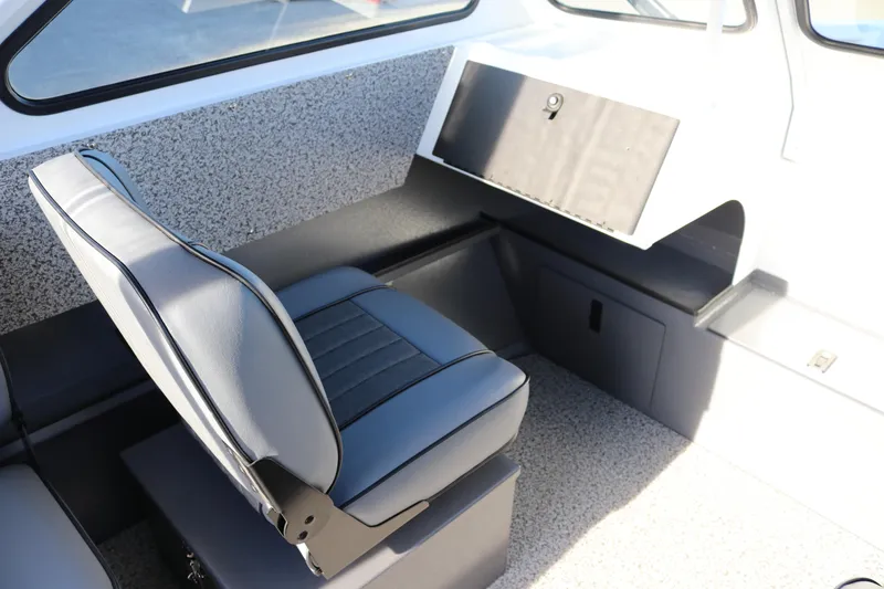 Slide: The Image of 2026 Alumaweld Stryker 202 boat interior with gray seating and storage compartment. - 8