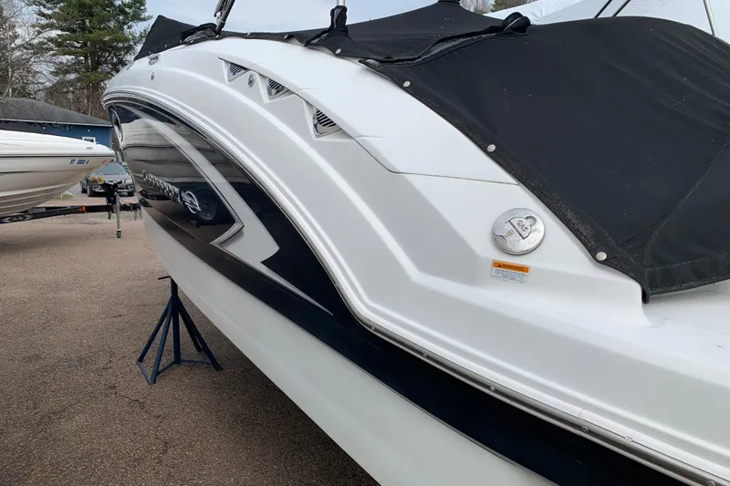 Slide: The Image of 2008 Chaparral Sunesta 224 boat with black cover, parked on stands. - 11