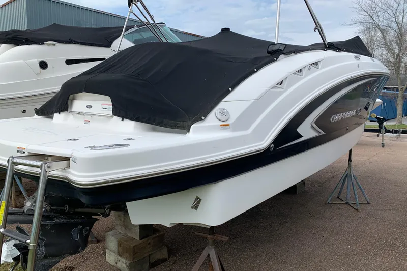 Slide: The Image of 2008 Chaparral Sunesta 224 boat with black cover, elevated on stands. - 12