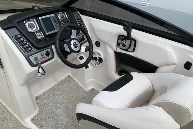 Slide: The Image of 2008 Chaparral Sunesta 224 boat cockpit with steering wheel and control panel. - 14