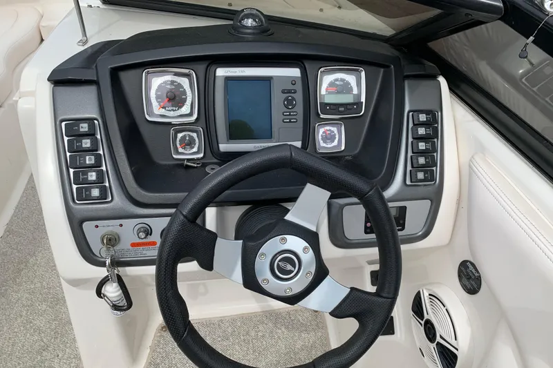 Slide: The Image of 2008 Chaparral Sunesta 224 dashboard with steering wheel and control panel. - 15