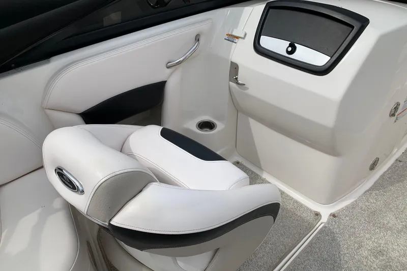 Slide: The Image of 2008 Chaparral Sunesta 224 boat interior with white seating and storage compartment. - 16