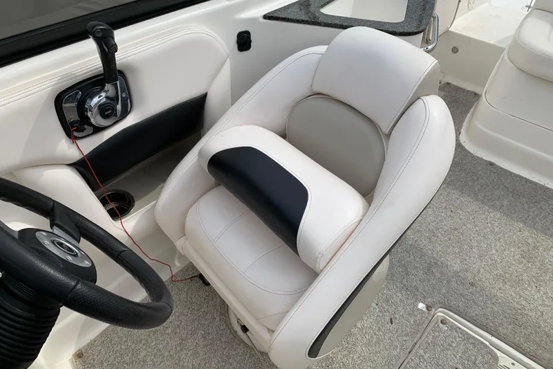 Slide: The Image of Captain's seat and controls of a 2008 Chaparral Sunesta 224 boat. - 17