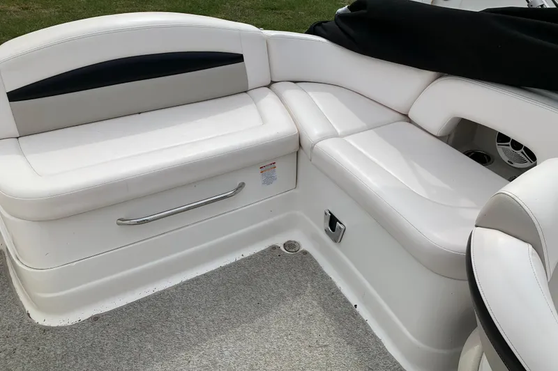 Slide: The Image of 2008 Chaparral Sunesta 224 boat interior with white cushioned seating. - 19
