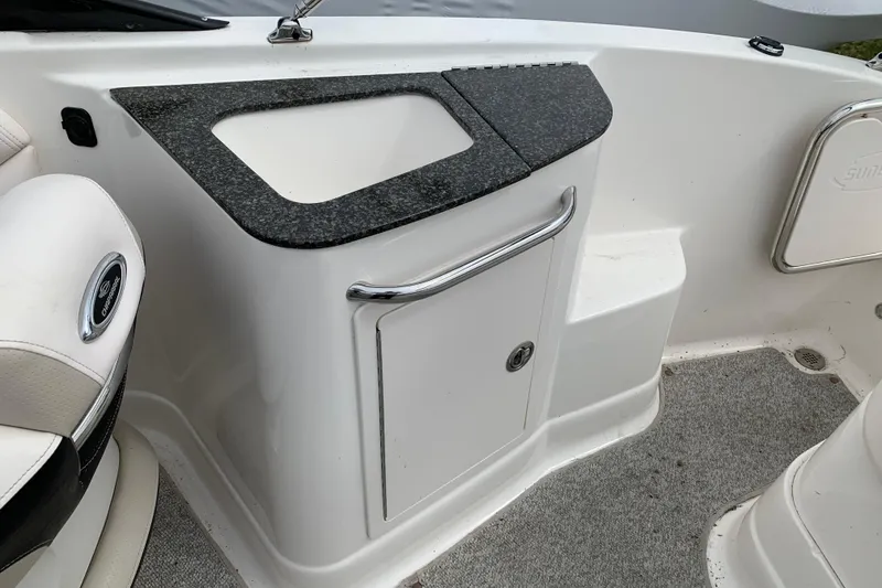 Slide: The Image of 2008 Chaparral Sunesta 224 boat interior with storage compartment and seating. - 21