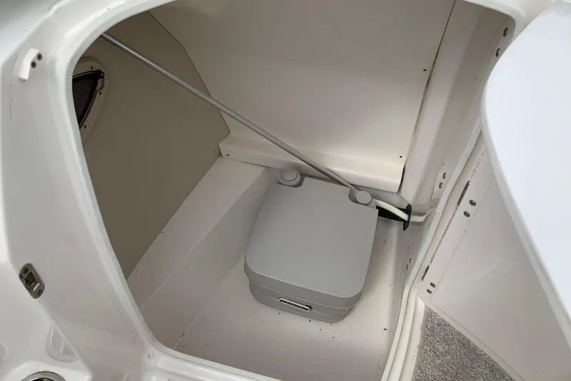 Slide: The Image of 2008 Chaparral Sunesta 224 boat interior with portable toilet in storage compartment. - 22