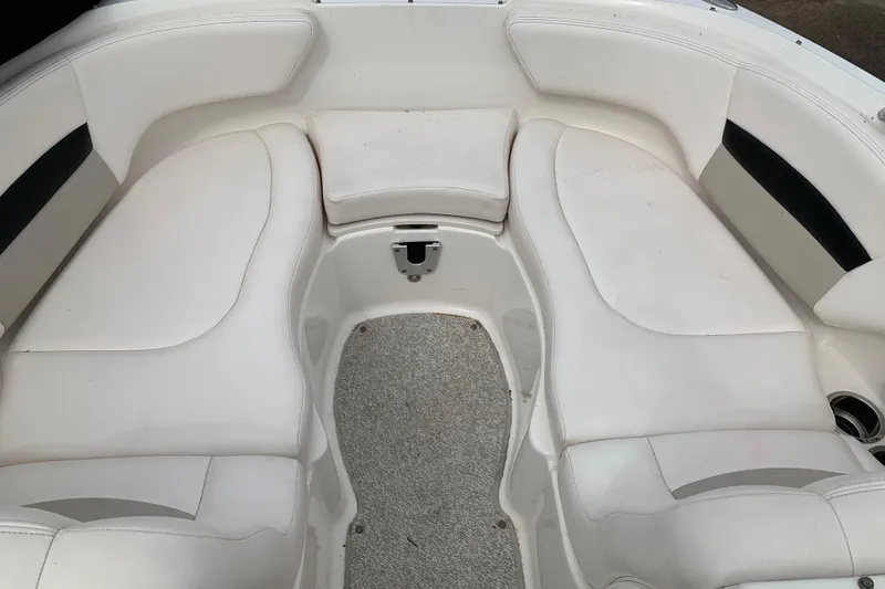 Slide: The Image of 2008 Chaparral Sunesta 224 boat interior with white cushioned seating. - 23
