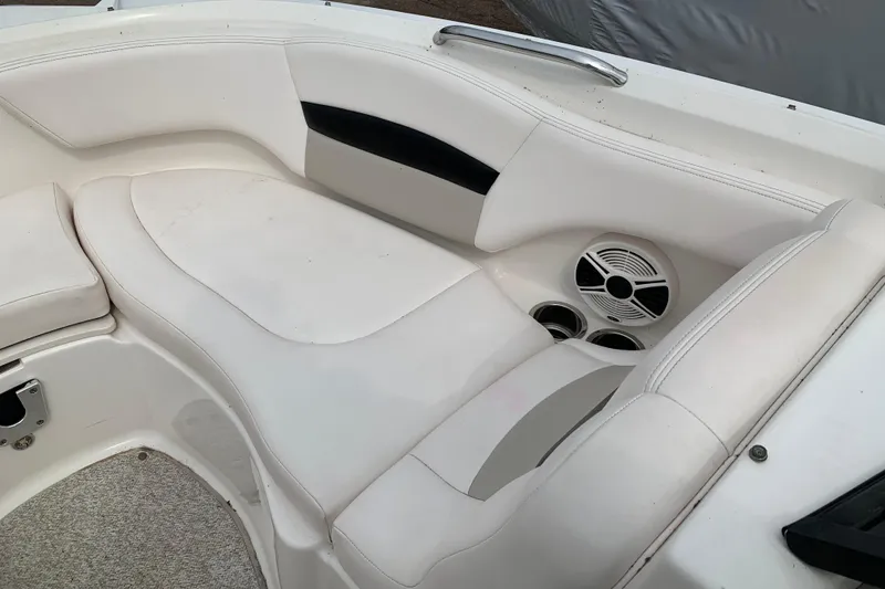 Slide: The Image of 2008 Chaparral Sunesta 224 boat interior with white seating and speaker system. - 24
