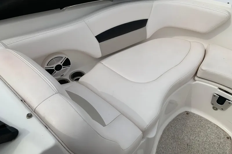 Slide: The Image of 2008 Chaparral Sunesta 224 boat interior with white seating and speaker system. - 26