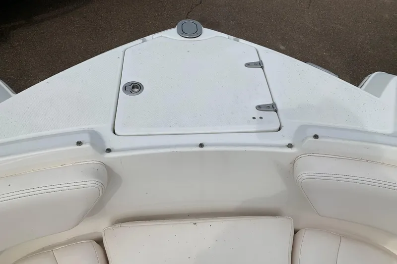 Slide: The Image of 2008 Chaparral Sunesta 224 boat bow with white seating and storage compartment. - 27