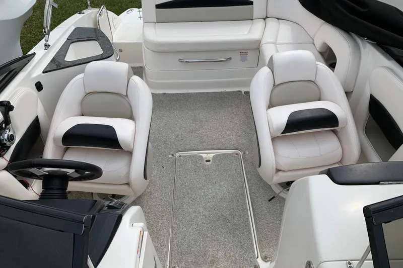 Slide: The Image of 2008 Chaparral Sunesta 224 boat interior with white seating and steering wheel. - 28
