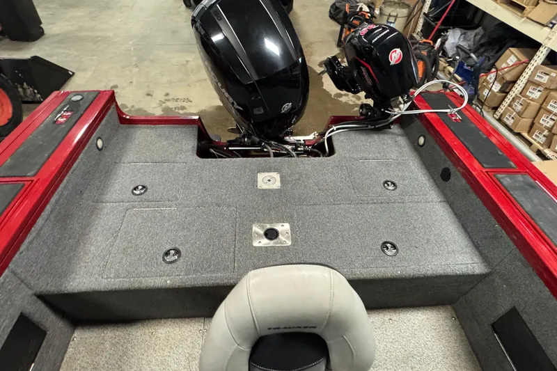 Slide: The Image of 2019 Tracker Targa V-18 WT boat interior with dual outboard motors in a garage setting. - 11