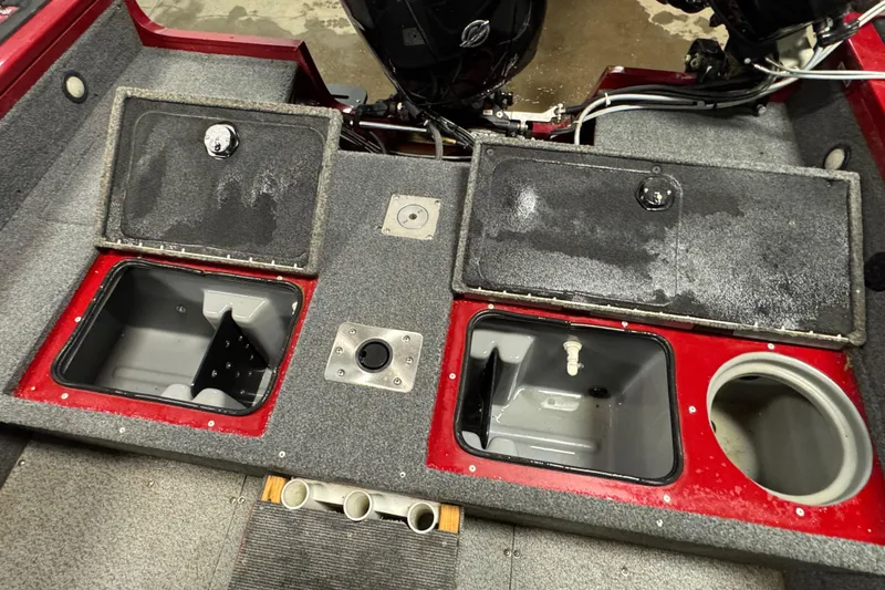 Slide: The Image of 2019 Tracker Targa V-18 WT boat interior with storage compartments and motor. - 13