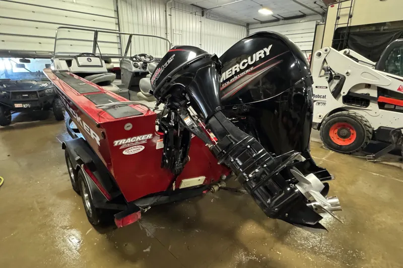 Slide: The Image of 2019 Tracker Targa V-18 WT boat with Mercury outboard motor in a garage setting. - 4