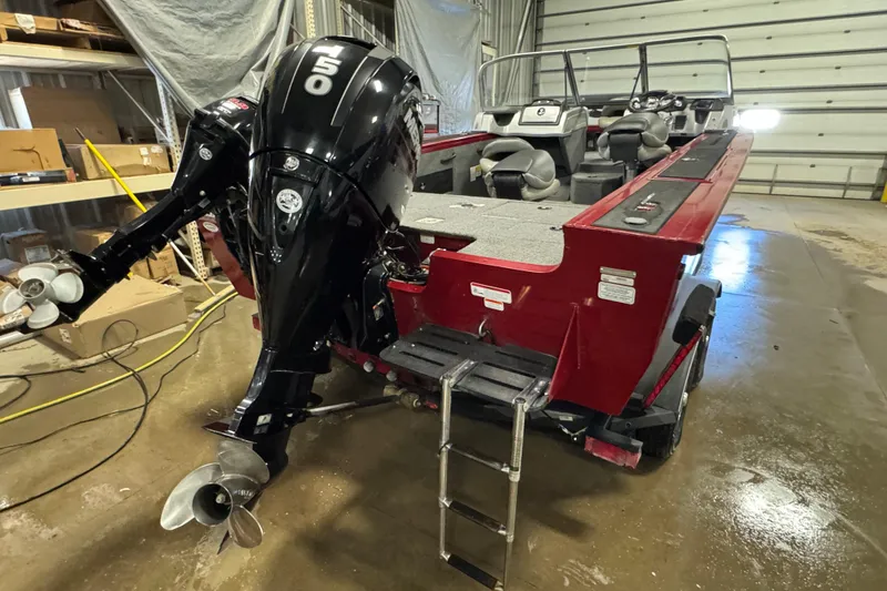 Slide: The Image of 2019 Tracker Targa V-18 WT boat with 150 HP engine in a garage setting. - 5