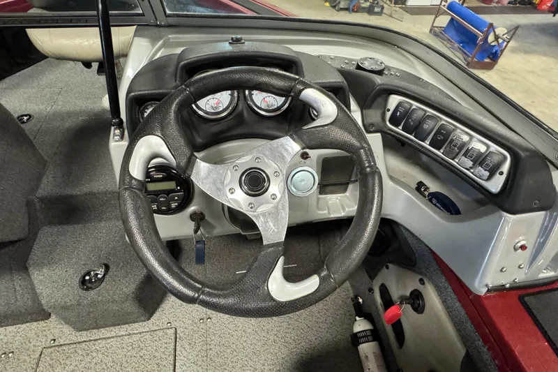 Slide: The Image of 2019 Tracker Targa V-18 WT boat dashboard with steering wheel and control panel. - 7