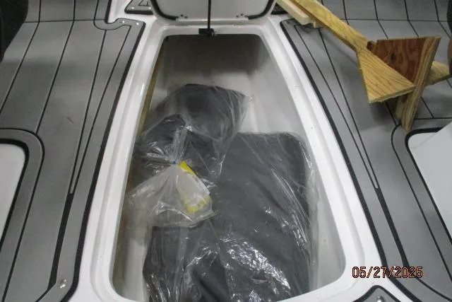 Slide: The Image of Storage compartment of 2025 Tahoe 210 Si boat with packaged items inside. - 12