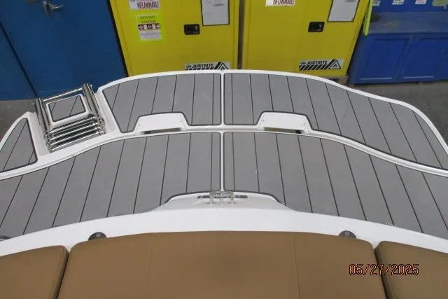 Slide: The Image of 2025 Tahoe 210 Si boat deck with gray non-slip surface and foldable ladder. - 14