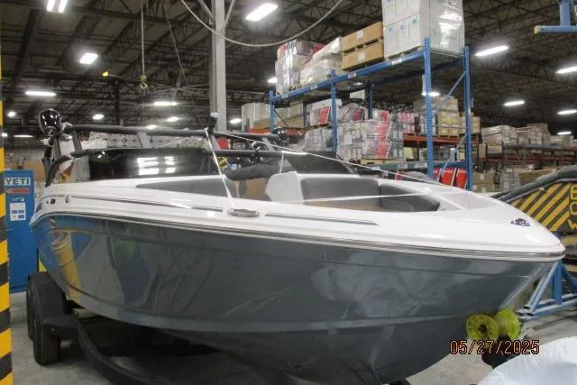 Slide: The Image of 2025 Tahoe 210 Si boat in warehouse, surrounded by shelves and boxes. - 17