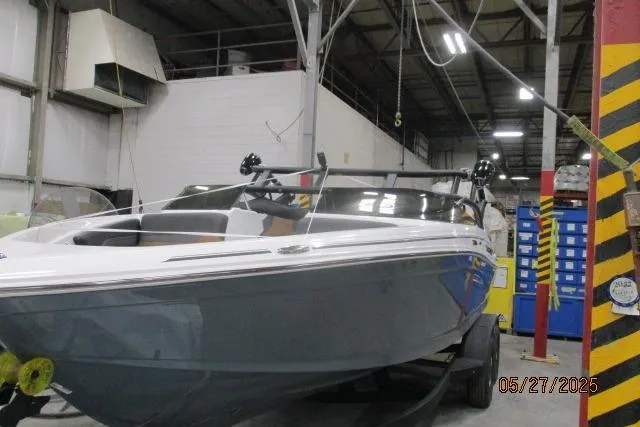 Slide: The Image of 2025 Tahoe 210 Si boat in a workshop setting, showcasing sleek design and modern features. - 18