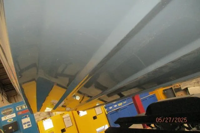 Slide: The Image of Underneath view of a 2025 Tahoe 210 Si boat in a workshop setting. - 22