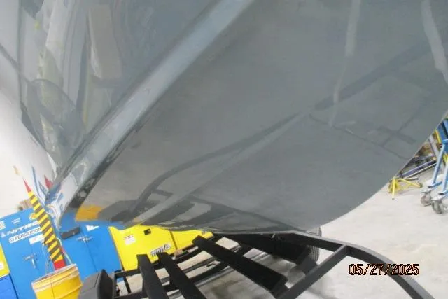 Slide: The Image of 2025 Tahoe 210 Si boat hull on trailer in a workshop setting. - 23