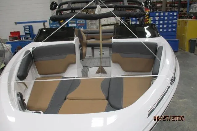 Slide: The Image of 2025 Tahoe 210 Si boat interior with tan and gray seating in a workshop setting. - 3