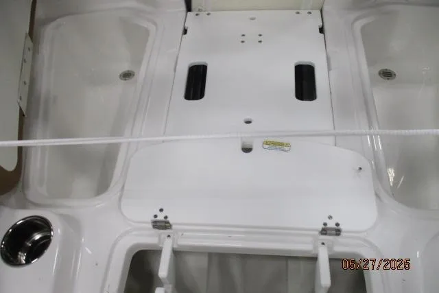 Slide: The Image of 2025 Tahoe 210 Si boat interior with storage compartments and cup holder. - 6