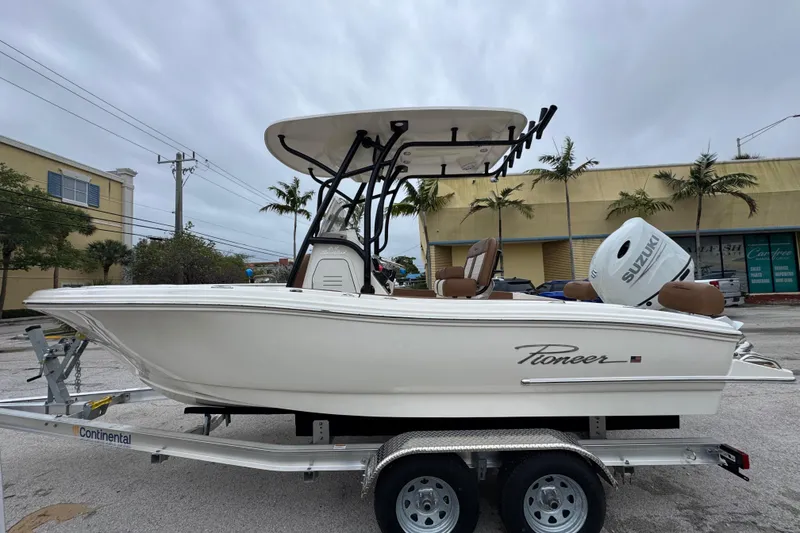 The Image of 2026 Pioneer 202 Sportfish boat on trailer with Suzuki outboard motor. - 0