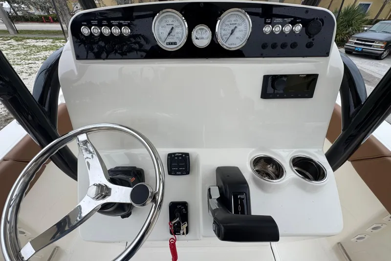 Slide: The Image of 2026 Pioneer 202 Sportfish dashboard with steering wheel, gauges, and controls. - 10
