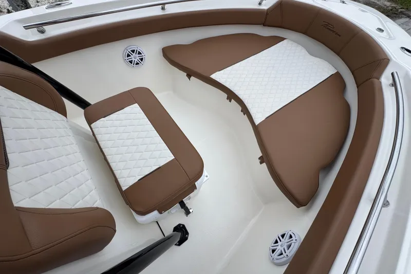 Slide: The Image of 2026 Pioneer 202 Sportfish boat interior with brown and white cushioned seating. - 12