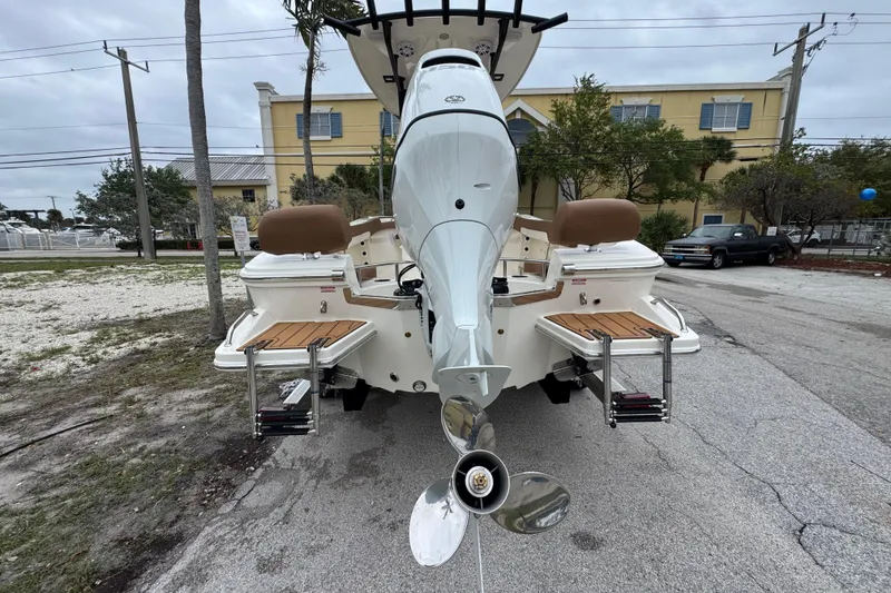 Slide: The Image of Rear view of 2026 Pioneer 202 Sportfish boat with outboard motor and swim platforms. - 3