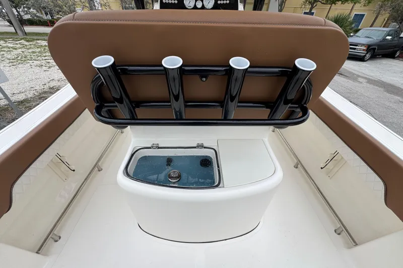 Slide: The Image of 2026 Pioneer 202 Sportfish boat interior with rod holders and livewell. - 7