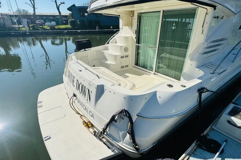 Slide: The Image of 2000 Sea Ray 400 Sedan Bridge docked, featuring spacious rear deck and elegant design. - 12