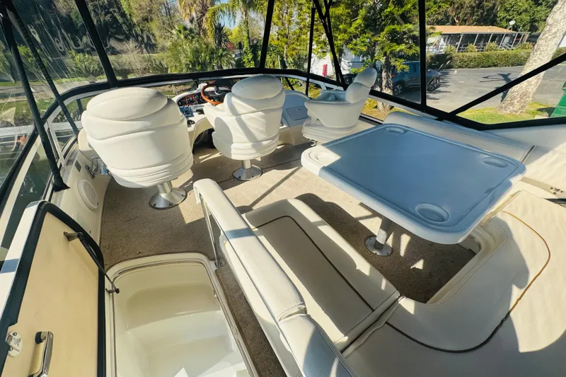 Slide: The Image of Interior view of 2000 Sea Ray 400 Sedan Bridge yacht with seating and table. - 15