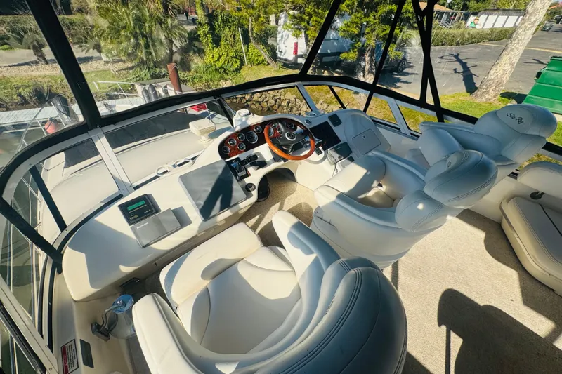 Slide: The Image of Cockpit of 2000 Sea Ray 400 Sedan Bridge with white leather seating and control panel. - 16