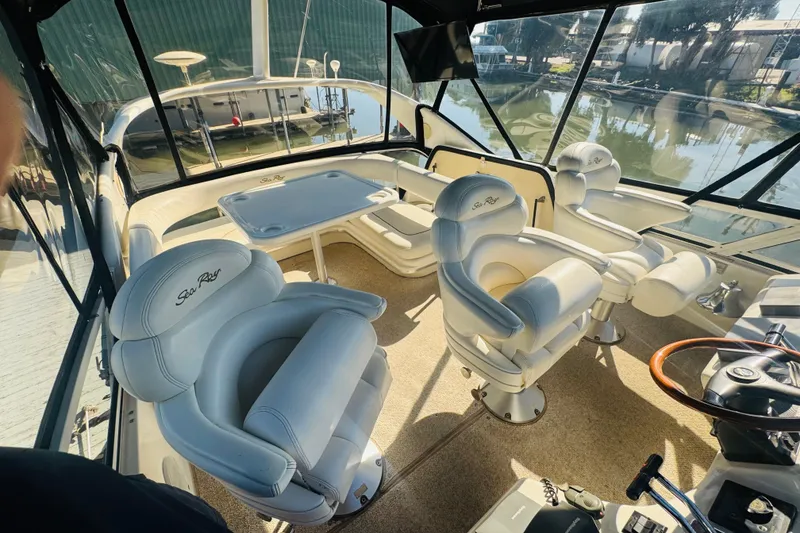 Slide: The Image of Interior of 2000 Sea Ray 400 Sedan Bridge with plush seating and helm. - 17