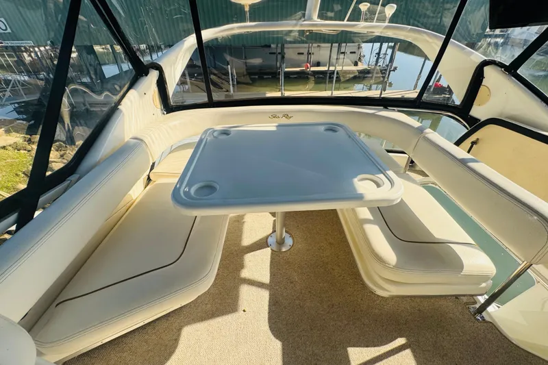 Slide: The Image of Interior of 2000 Sea Ray 400 Sedan Bridge with seating and table. - 18