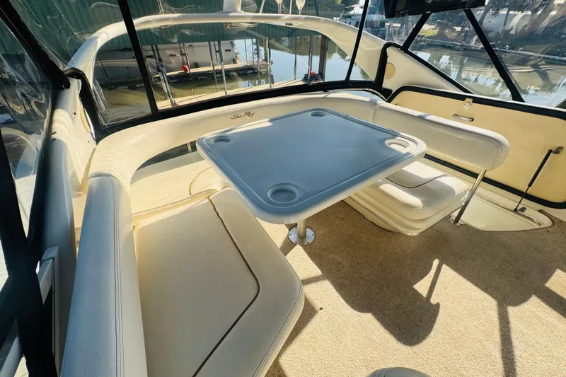 Slide: The Image of Interior of 2000 Sea Ray 400 Sedan Bridge with seating and table. - 19