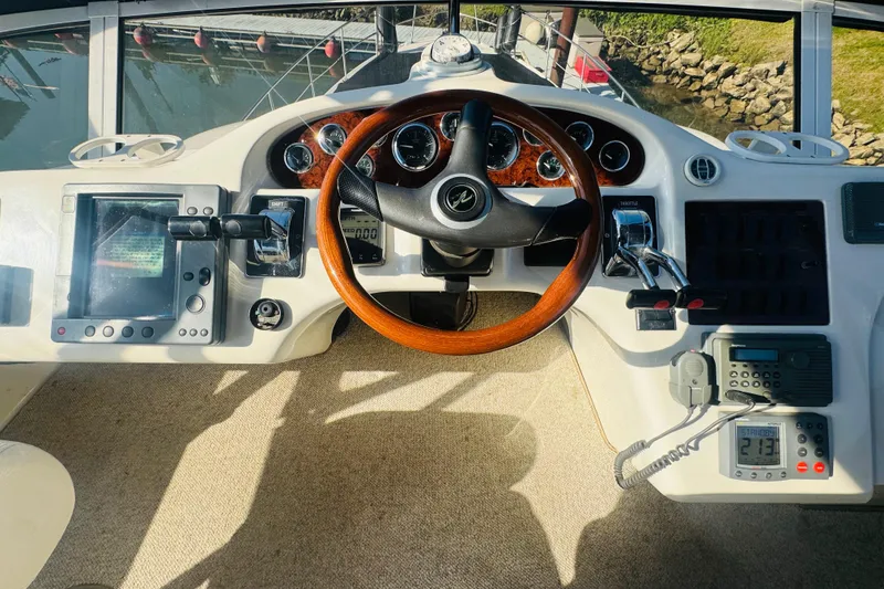 Slide: The Image of Cockpit of 2000 Sea Ray 400 Sedan Bridge with steering wheel and navigation controls. - 23